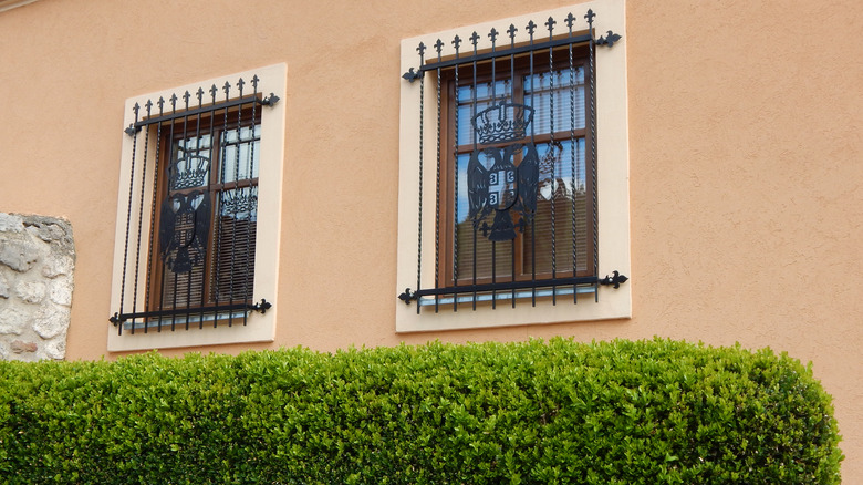 wrought-iron window accents on a stucco wall