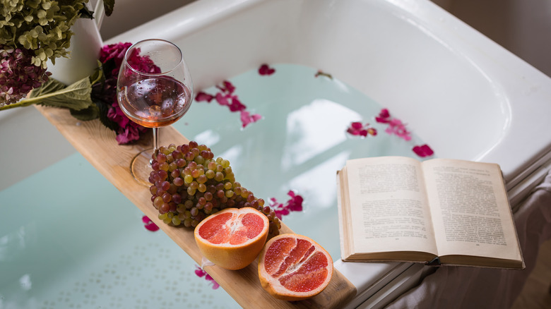 bathtub tray with fruit and book