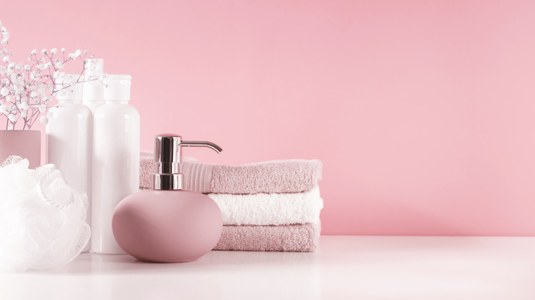 pink wall, towel and dispenser 