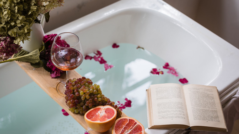 bathroom caddy with wine and book