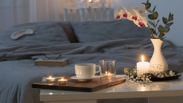 Candles and flowers in bedroom