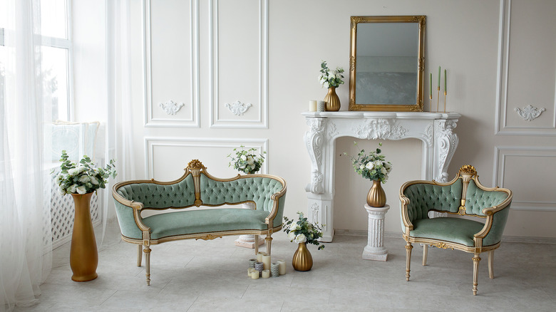 antique couches and gold framed mirror