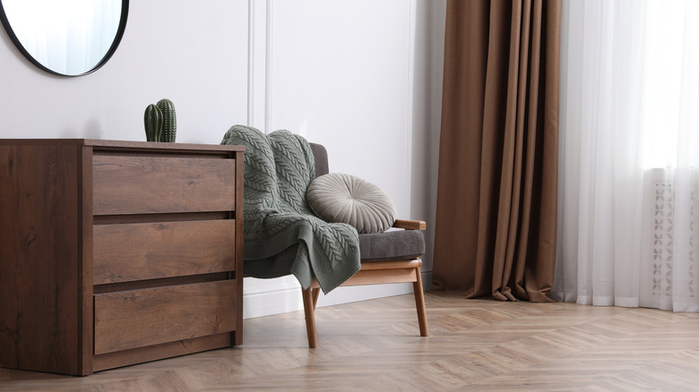 wooden dresser and brown curtain