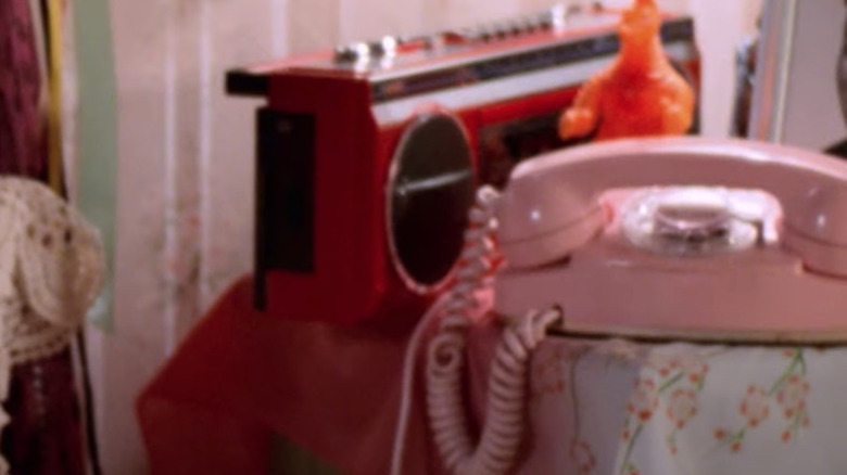 Pink corded telephone on bedside table