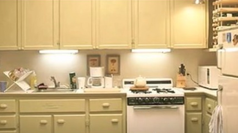 yellow kitchenette with cabinets