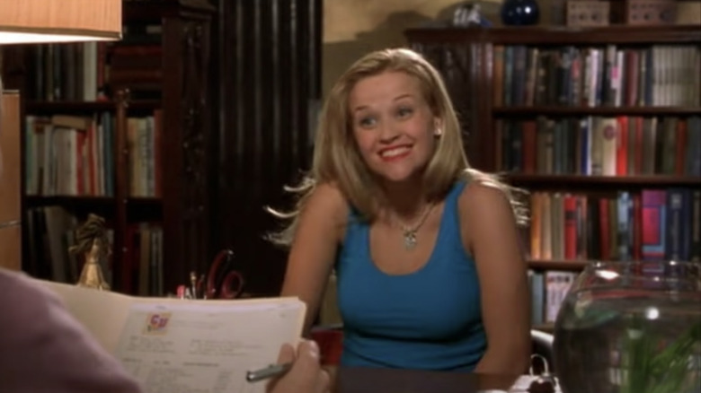 Elle Woods smiling in library 