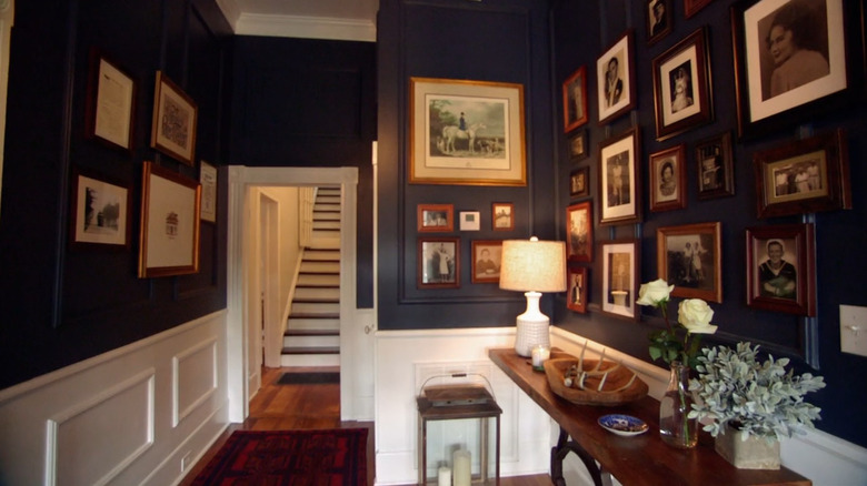 A dark entryway with a gallery wall