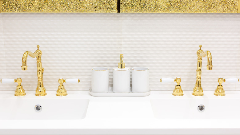 bathroom with gold sink faucets