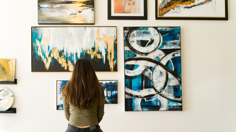 girl looking at paintings 