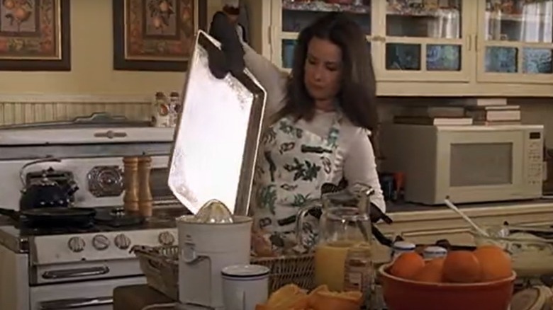 woman holding pan in kitchen