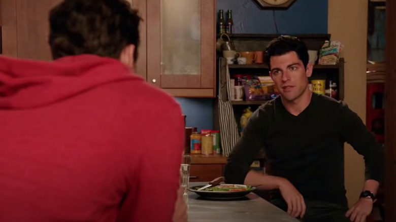 Schmidt sits in the kitchen