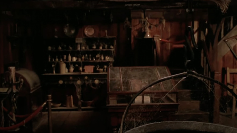 Shelves of glass bottles and jars line a wall.