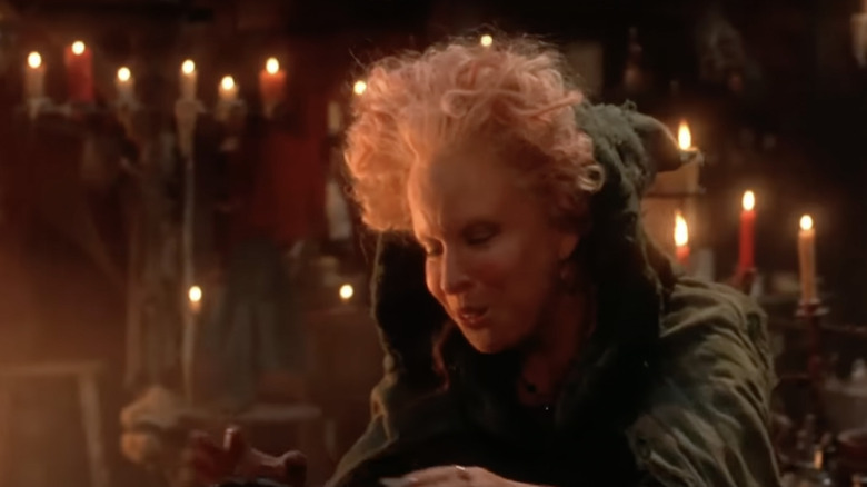 Winifred Sanderson stands in front of countless lit candles.