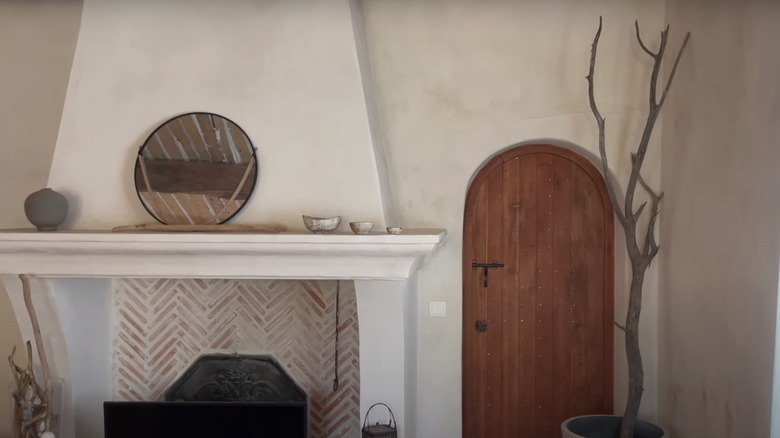 stone fireplace and wooden door