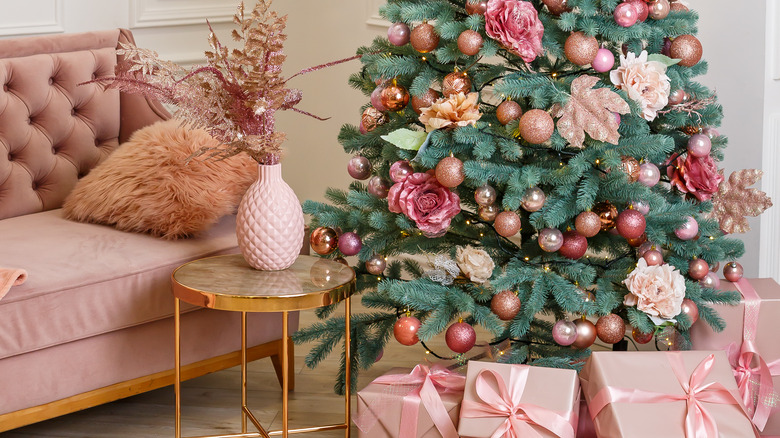 pink couch and ornaments on christmas tree
