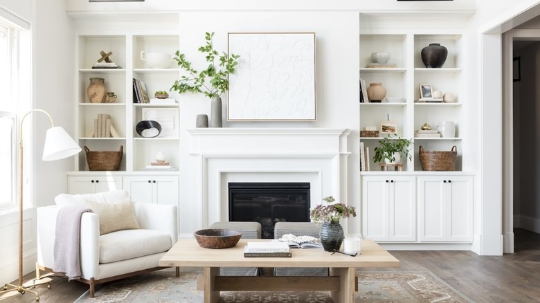 white bookcase and fireplace