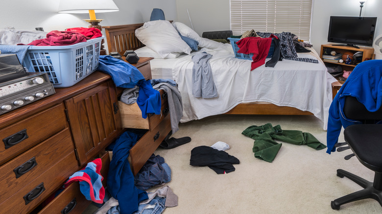 bedroom with clutter clothes on floor