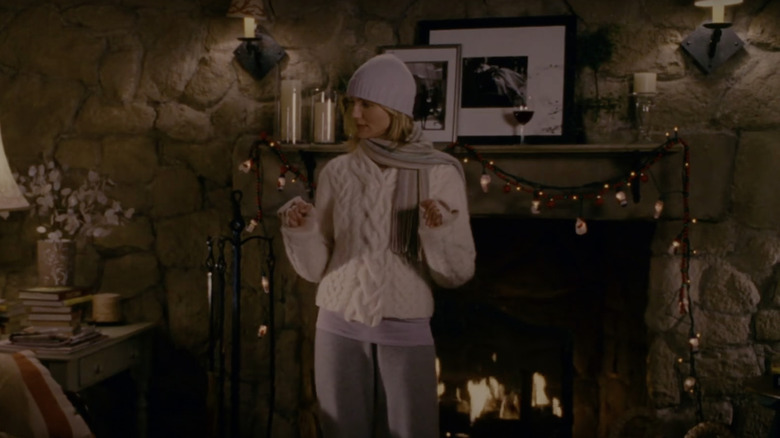 Amanda standing by stone fireplace 