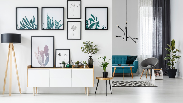 teal gallery wall and sofa