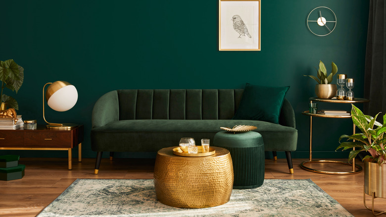 green sofa with gold accents