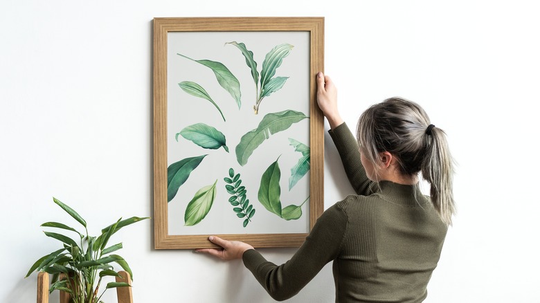 woman hanging botanical print