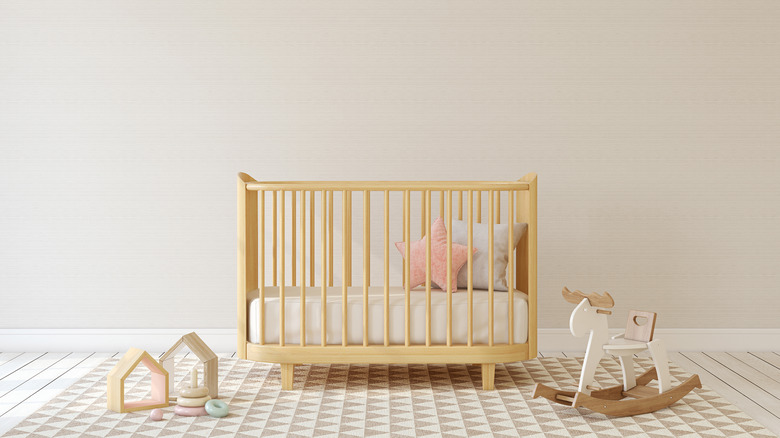 light wood crib in nursery