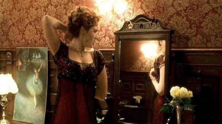 rose adjusting dress in mirror