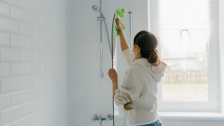 cleaning glass door on shower