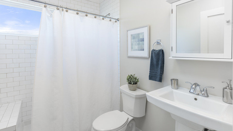 white bathroom with shower curtain