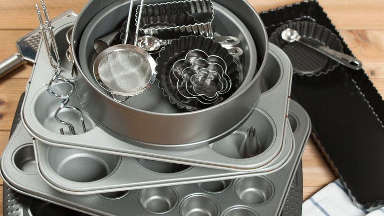 pile of bakeware and cookie cutters