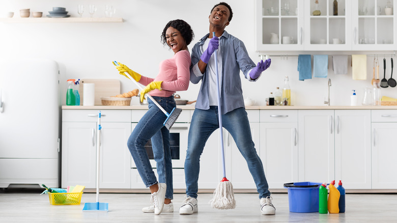 couple singing while cleaning