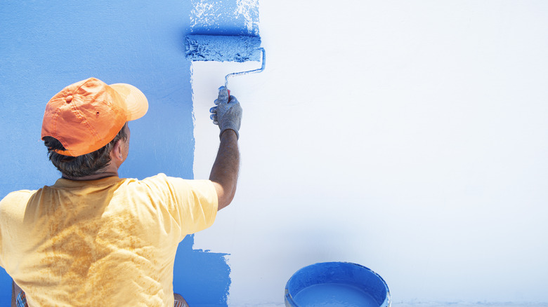 Man painting concrete blue