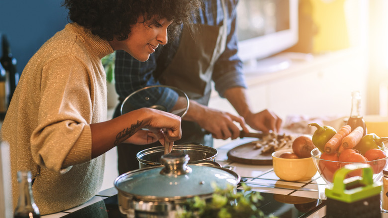 two people cooking in kitchen