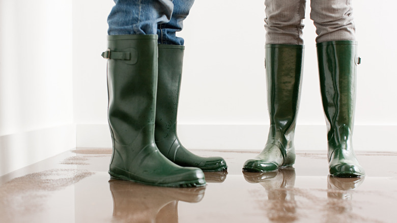 people with boots standing in flood