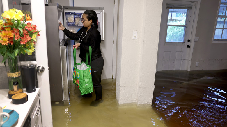 person standing in flooded kitchen