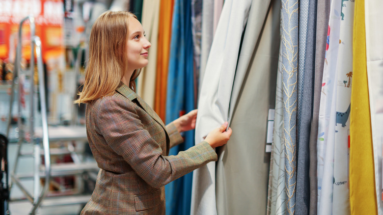 Woman shopping for curtains in store