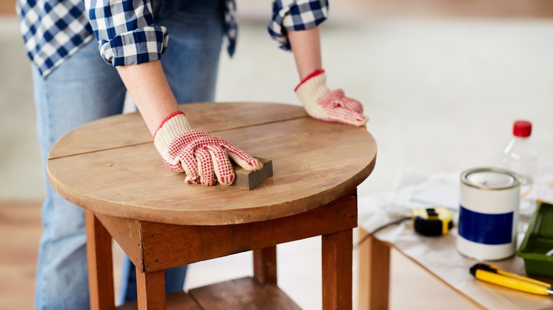 Woman sanding down table