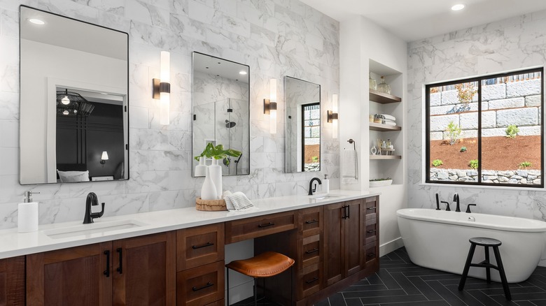 wall sconces surrounding bathroom mirror