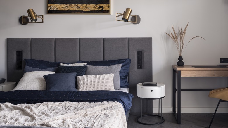 two sconces above bedroom headboard