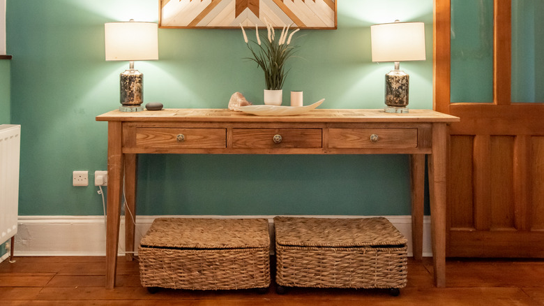 Two matching table lamps on console table.