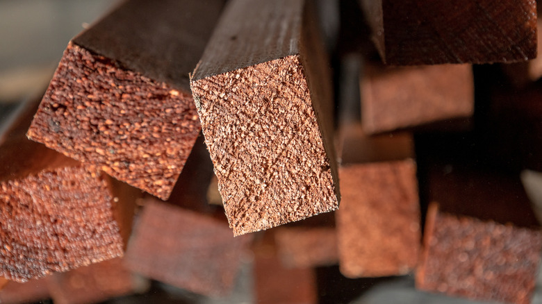 A stack of wooden boards that have been pressure treated