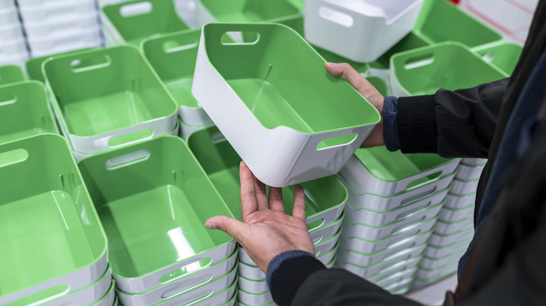 Person holding plastic storage bin