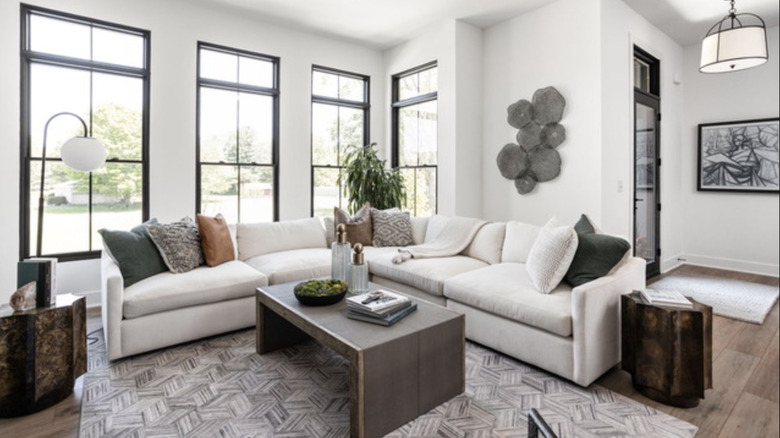 A living room and foyer separated with a sofa