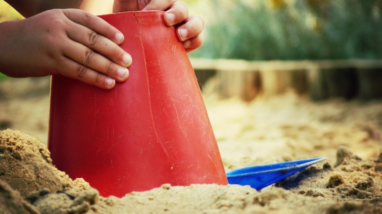 child playing in sand