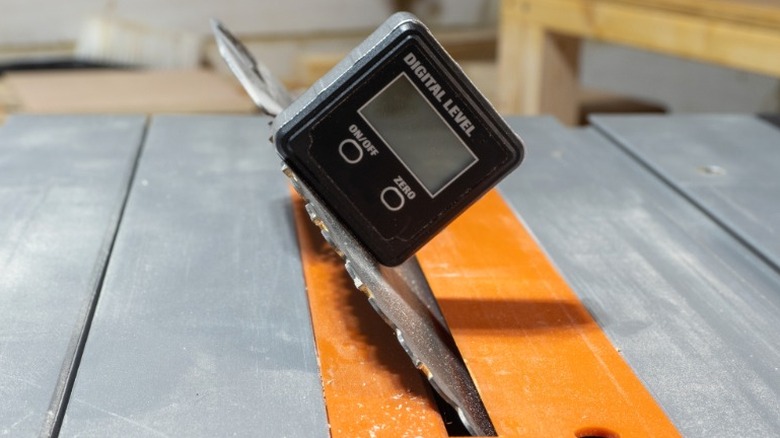 Digital level sitting on angled table saw blade