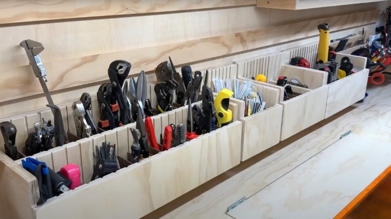 Wood storage bins filled with tools in a garage