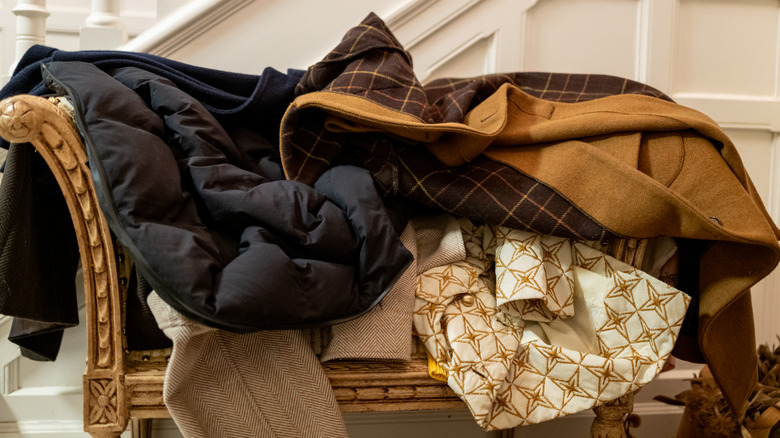 Messy pile of coats on a chair