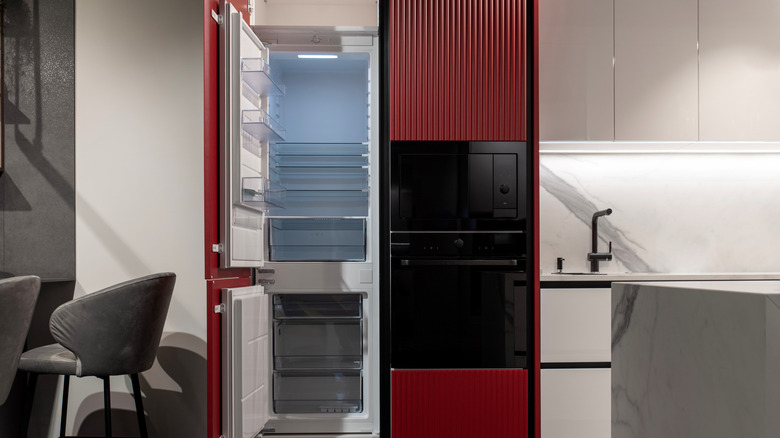 A modern gray kitchen with a built-in refrigerator