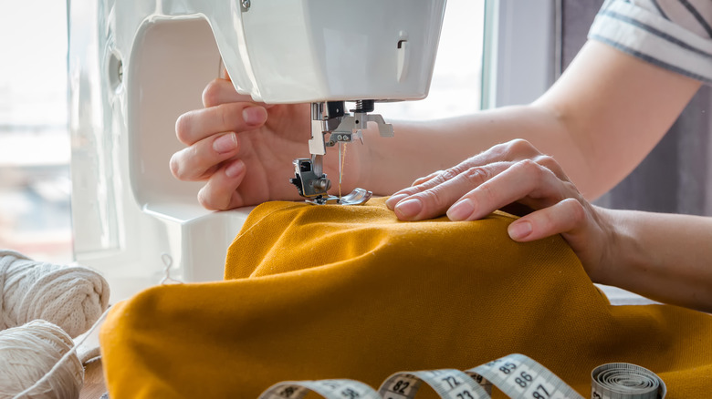 hands sewing with machine