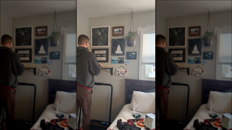 man using folding desk mounted on wall